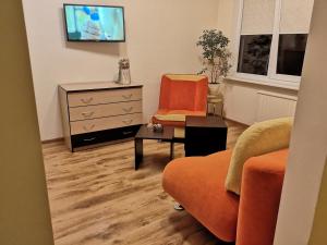 a living room with a couch and a dresser at Kalniečiai park apartment in Kaunas