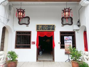 喬治市的住宿－Apple Backpackers Hotel，白色的建筑,有红色的窗帘和门廊