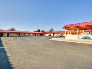 an empty parking lot in front of a motel at Route 66 Inn in Shamrock