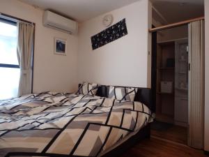a bedroom with a bed and a window at Kyo No Yado Nishioji inn in Kyoto +182 photos