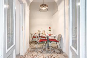 a dining room with a table and chairs at Casa Rowe B&B in Pistoia