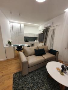 a living room with a couch and a table at Smaragdo apartamentai in Kaunas