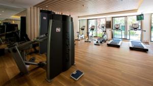 a gym with several tread machines in a room at Peaceful Pool-access room - Q seaside Hua Hin in Phetchaburi