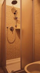 a shower in a bathroom with a toilet and a sink at Mare Smeraldo Appartamento in Villasimius