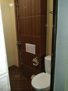 a bathroom with a toilet and a toilet paper dispenser at Villa Gracia in Ravda +50 photos
