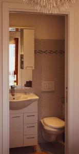 a bathroom with a sink and a toilet at Mare Smeraldo Appartamento in Villasimius