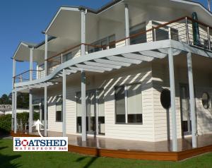 een groot wit huis met een balkon bij the boatshed waterfront b&b in Port Fairy
