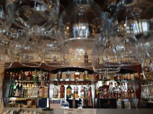 a bar filled with lots of bottles and glasses at Hotel Condor in Oraviţa