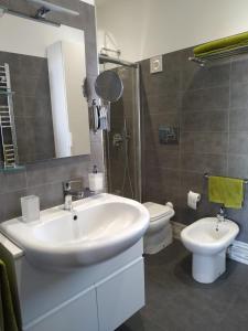 a bathroom with a sink and a toilet at Michi's Home - Attico in Centro in Bari