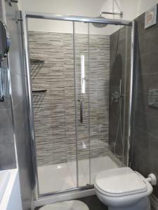 a bathroom with a shower with a toilet at Michi's Home - Attico in Centro in Bari