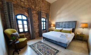 Ένα ή περισσότερα κρεβάτια σε δωμάτιο στο Al Qualaa Boutique Hotel