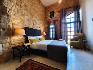 A bed or beds in a room at Al Qualaa Boutique Hotel