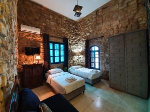 Ένα ή περισσότερα κρεβάτια σε δωμάτιο στο Al Qualaa Boutique Hotel