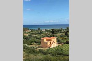 a house on a hill with the ocean in the background at Rodanthy II in Katelios