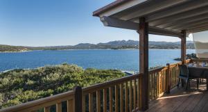 a deck with a view of the water at Isola dei Gabbiani - Land of water in Porto Pollo