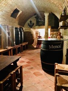 a wine tasting room with a large barrel and tables at HABITACIONES LAS TERMAS in Guadix