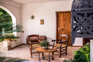 a living room filled with furniture and a table at Hacienda Minerva in Zuheros