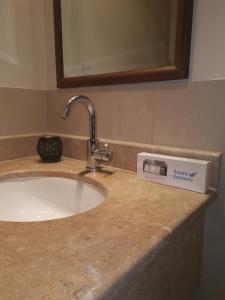 a bathroom counter with a sink and a mirror at شقة مارينا البيلسان - عائلات فقط in King Abdullah Economic City