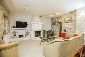 a living room with a couch and a fireplace at Luxury villa Luck in Imotski, private pool in Imotski