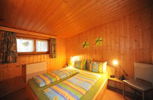 a bedroom with a bed in a wooden room at Maurer Ferienwohnungen in Bodenmais