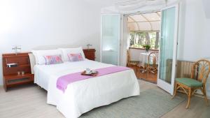 - une chambre avec un lit et un balcon avec une table dans l'établissement Villa Scultura Seaview, à Lignano Sabbiadoro