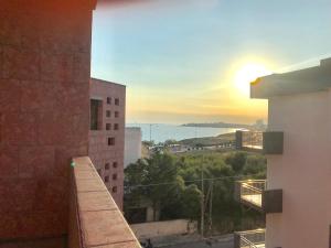 a view of the sunset from the balcony of a building at Trilocale Lalla sul mare in Gallipoli