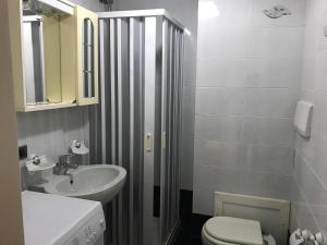 a bathroom with a toilet and a sink and a shower at Trilocale Lalla sul mare in Gallipoli +17 photos
