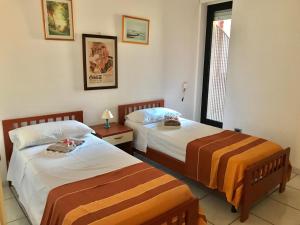 a bedroom with two beds and a window at Trilocale Lalla sul mare in Gallipoli