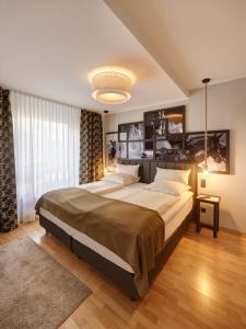 a bedroom with a large bed and a large window at Art Hotel Superior in Aachen