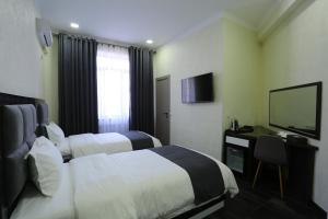 Postel nebo postele na pokoji v ubytování Hotel 777
