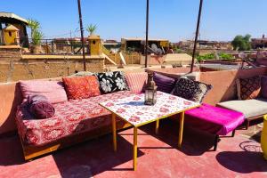 a couch sitting on a patio with a table at Hostel Kif-Kif in Marrakesh