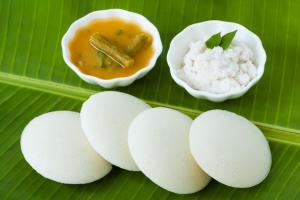 a group of white food on a green banana leaf at Sun Shine in Chennai