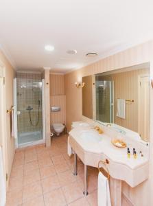 a bathroom with a tub and a sink and a toilet at Акку in Astana