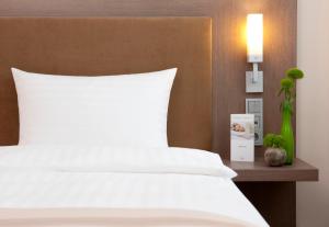 Postel nebo postele na pokoji v ubytování IntercityHotel Berlin Hauptbahnhof