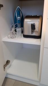a toaster sitting on a shelf in a kitchen at Apartament Fibra Essenza in Rybnik