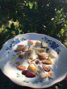 a white plate with nuts and fruit on it at Villa Valentina Issyk-Kul in Grigor'yevka