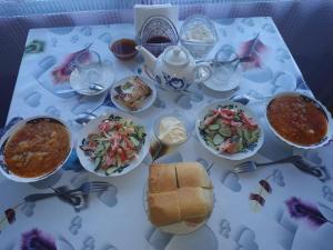 a table with plates of food and bowls of soup at Villa Valentina Issyk-Kul in Grigor'yevka