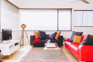 a living room with two couches and a tv at Dalblair Bed & Breakfast in Seville