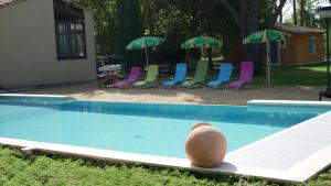 a ball sitting on the edge of a swimming pool at L'eau vive in Saint-Martin-de-la-Brasque +20 photos
