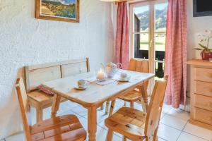 a table and chairs in a kitchen with a window at Jaudenhof - Apartment Kotalm in Lenggries