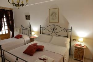 um quarto com duas camas e duas mesas com candeeiros em Dimora Carmine em Alberobello