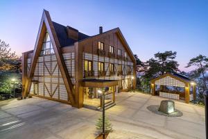 a large house with a gambrel roof at Hancioglu Orman Evleri (Bungalow) & Hotel in Trabzon