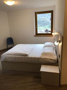 Posteľ alebo postele v izbe v ubytovaní MOUNTAIN RESORT Appartamenti