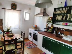 a kitchen with a table and a stove top oven at Finca El Trazo in Tacoronte