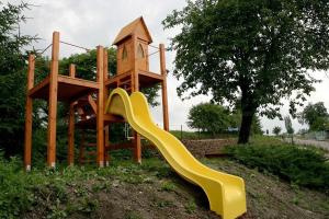 a wooden playground with a slide and a tower at Chalupa Bella in Žamberk