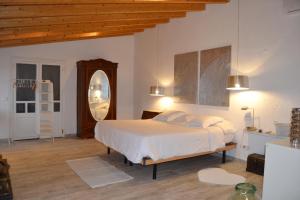 a bedroom with a large bed and a large mirror at Sa Posada in Estellencs