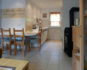 a kitchen with a table and chairs in a room at Ferienhaus Uda in Schwarzenberg