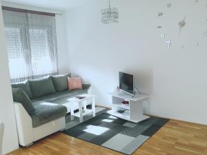 a living room with a couch and a tv at Apartman Natasha in Trebinje