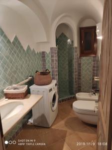 a bathroom with a toilet and a sink at Tamarici Garden in Cannigione +9 photos