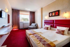 Postel nebo postele na pokoji v ubytování Hotel Capri + 23 fotografií